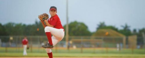 Boy pitching at a baseball game